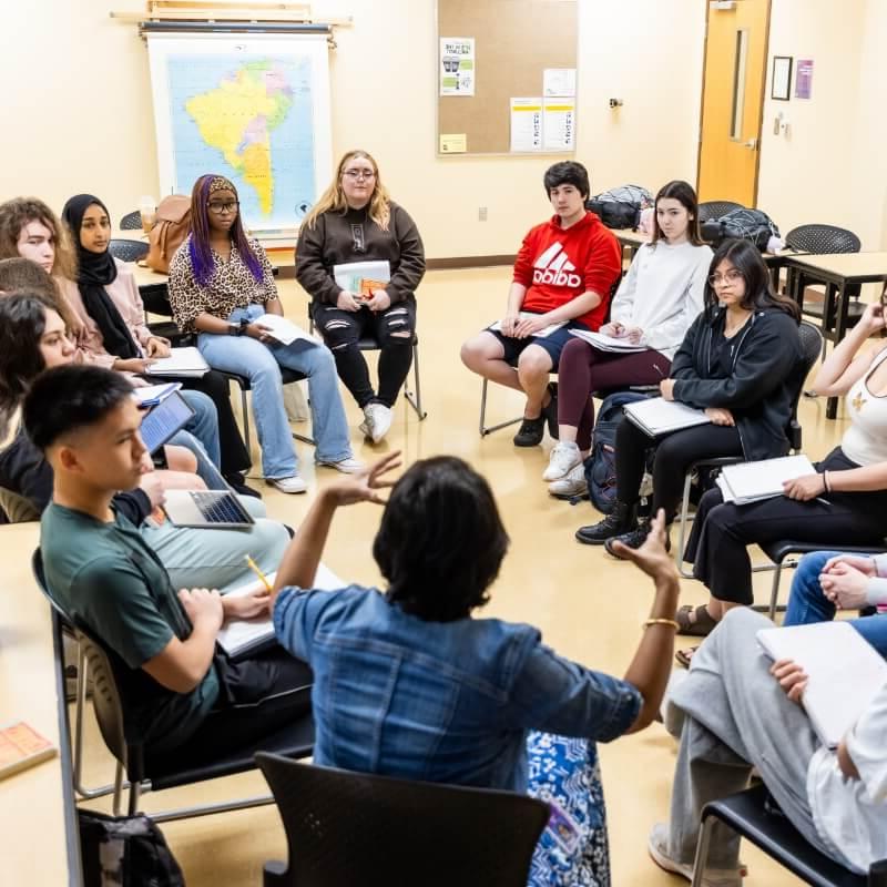 Classroom discussion with students sitting in a circle.